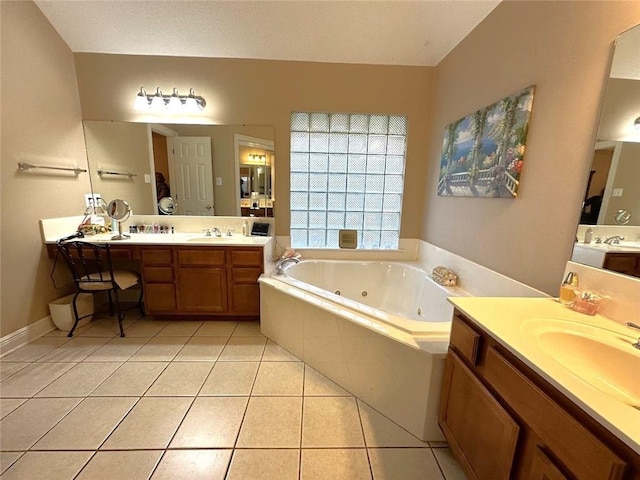 bathroom with vanity, tile patterned flooring, and tiled tub