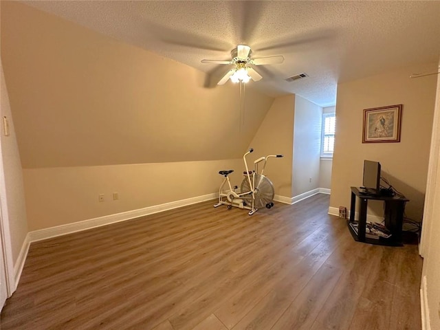 bonus room featuring a textured ceiling, hardwood / wood-style floors, lofted ceiling, and ceiling fan