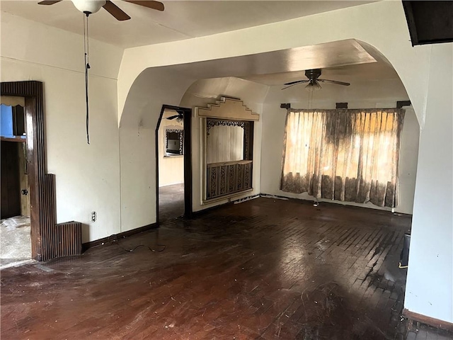 empty room with ceiling fan, lofted ceiling, and hardwood / wood-style floors