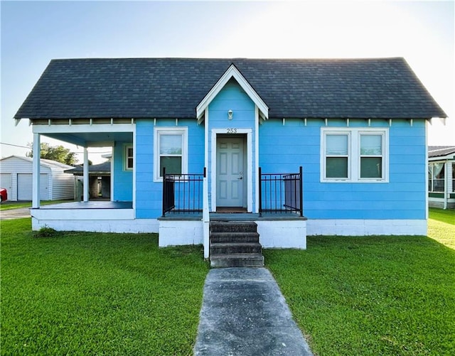 253 Central Ave, Reserve, LA 70084 - bungalow-style house featuring a shingled roof, a front lawn, and covered porch