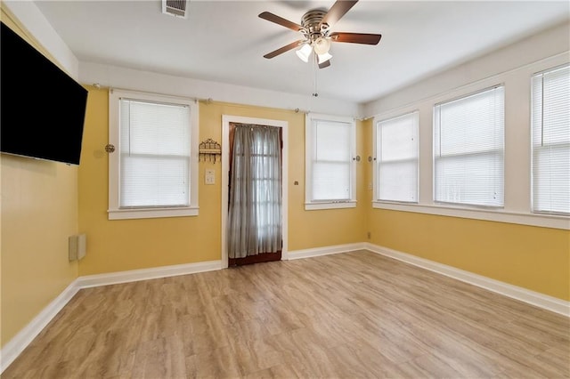 empty room with light hardwood / wood-style floors and ceiling fan