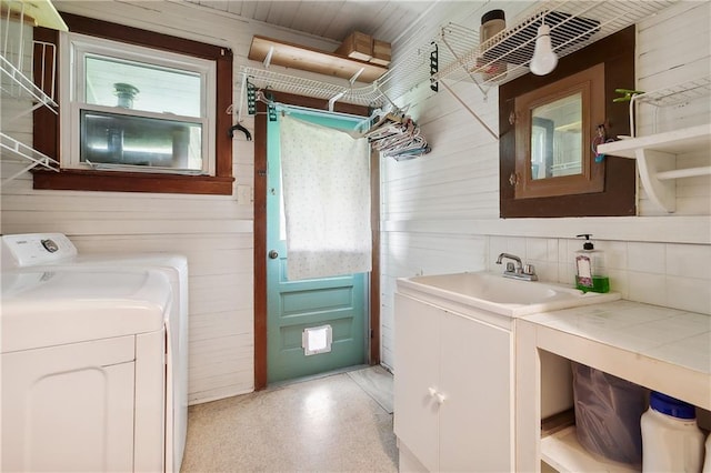 253 Central Ave, Reserve, LA 70084 - bathroom featuring wood walls, washing machine and clothes dryer, plenty of natural light, vanity, and backsplash