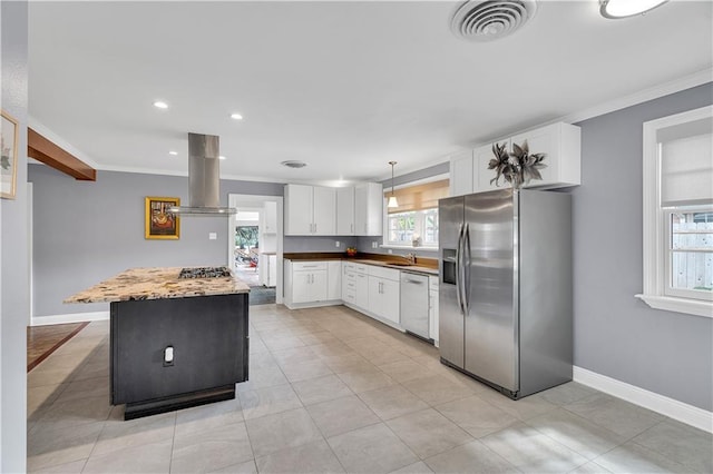 kitchen with visible vents, ornamental molding, island exhaust hood, a sink, and stainless steel appliances