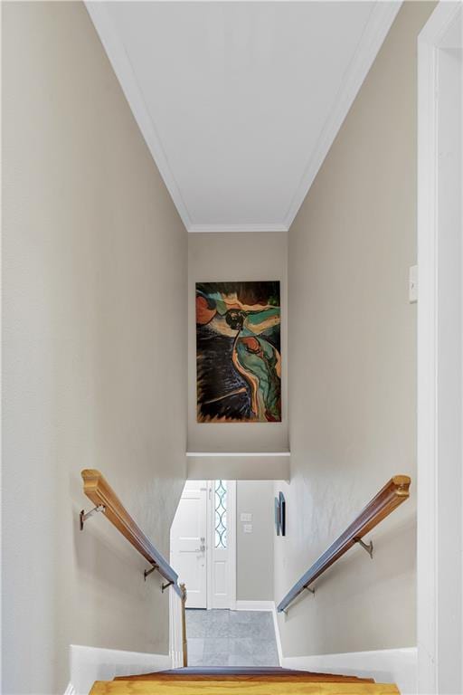 stairway featuring baseboards and ornamental molding