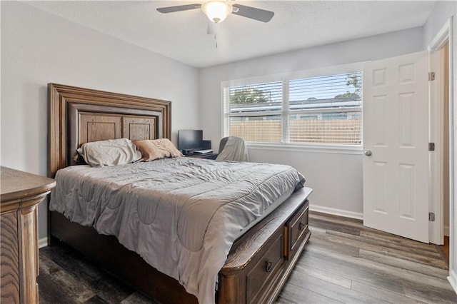 bedroom with wood-type flooring and ceiling fan