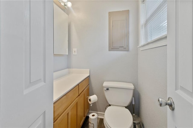 bathroom with vanity, electric panel, and toilet