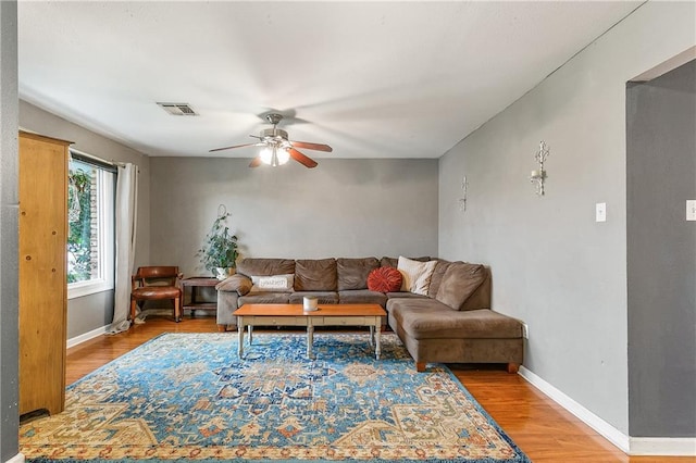 living room featuring ceiling fan and light wood-type flooring