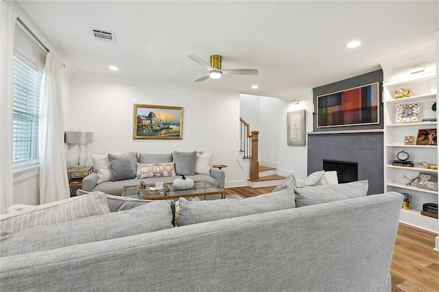 living room featuring ceiling fan and light wood-type flooring