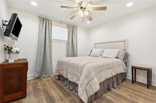 bedroom with hardwood / wood-style floors and ceiling fan