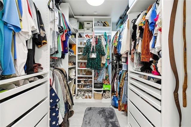 walk in closet featuring light tile patterned flooring