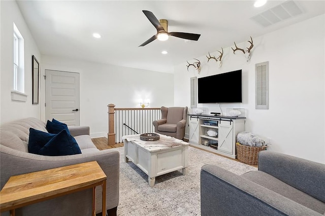 living room with ceiling fan and light hardwood / wood-style flooring