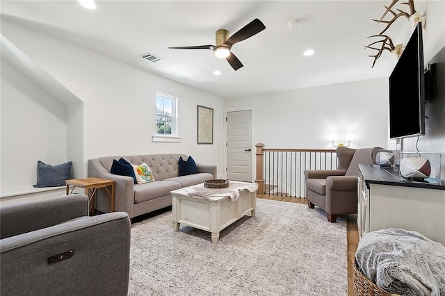 living room featuring light wood-type flooring and ceiling fan