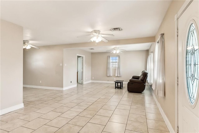 unfurnished room featuring ceiling fan and light tile patterned floors