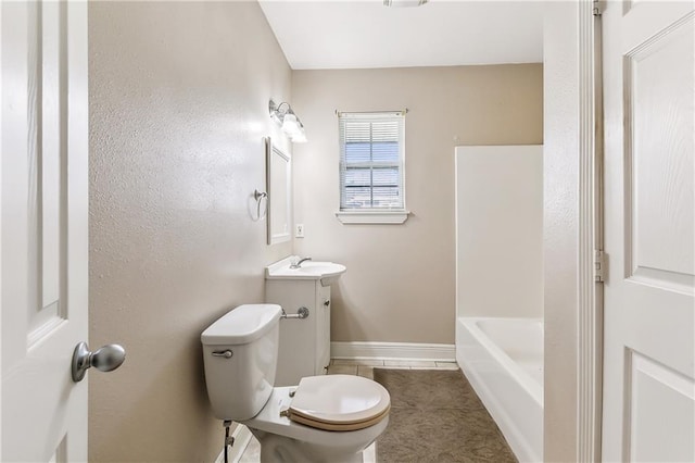 bathroom with a tub to relax in, vanity, toilet, and tile patterned flooring