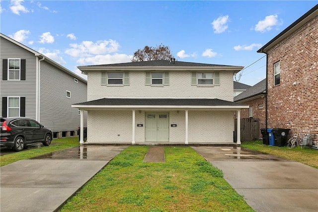 view of front property with a front lawn and covered porch