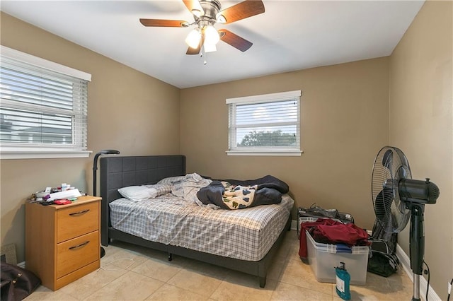 bedroom with ceiling fan and light tile patterned floors