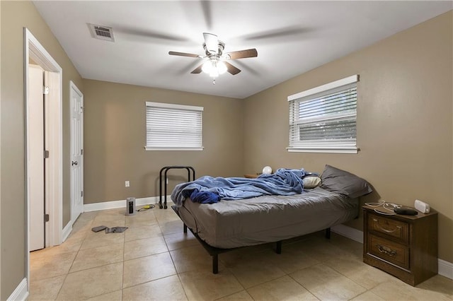 tiled bedroom featuring ceiling fan