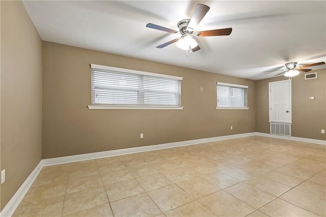 empty room with light tile patterned floors and ceiling fan