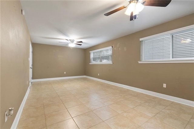 unfurnished room with light tile patterned floors and ceiling fan