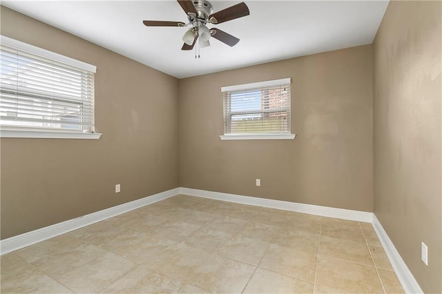 empty room with light tile patterned floors and ceiling fan