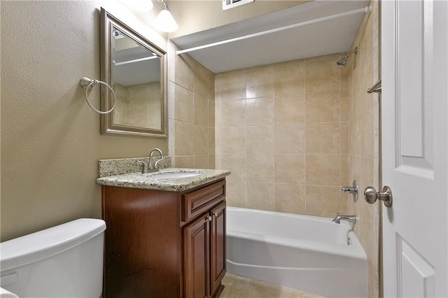 full bathroom featuring vanity, toilet, and tiled shower / bath