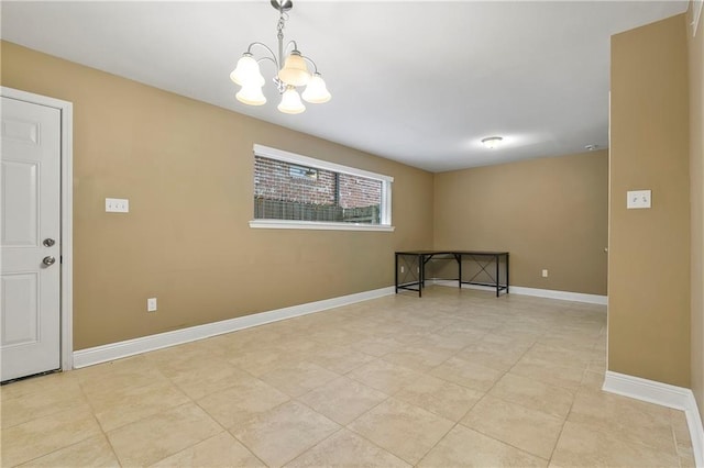 tiled spare room featuring an inviting chandelier