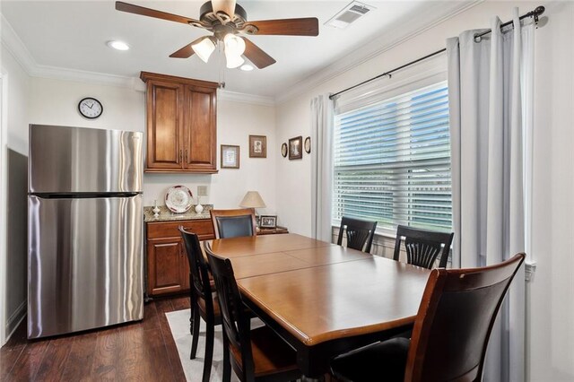 dining space with crown molding, dark hardwood / wood-style floors, and ceiling fan