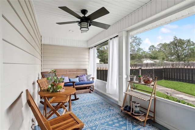 sunroom / solarium featuring ceiling fan