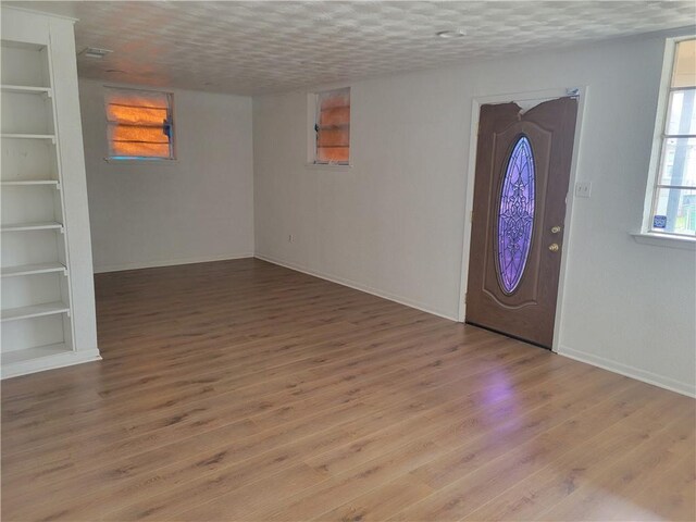 entrance foyer featuring wood-type flooring and a textured ceiling