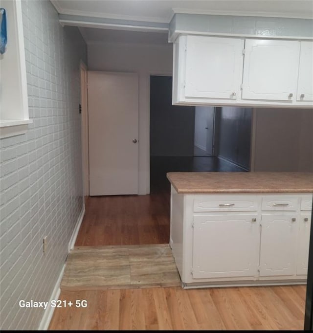 kitchen with white cabinets and light hardwood / wood-style flooring