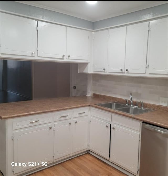 kitchen with white cabinetry, dishwasher, sink, and light hardwood / wood-style floors