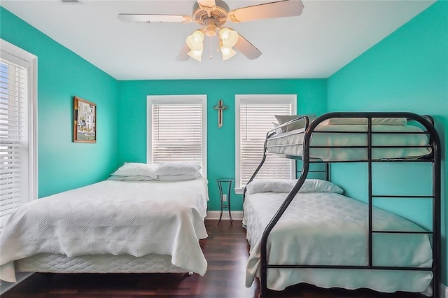 bedroom featuring dark wood-style floors, ceiling fan, and baseboards