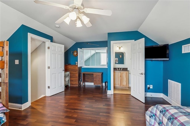 bedroom featuring dark wood-style floors, lofted ceiling, visible vents, and baseboards