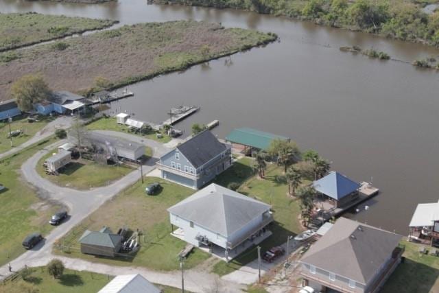 drone / aerial view with a water view and a residential view