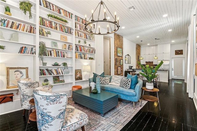 living area with an inviting chandelier, wooden ceiling, and built in features