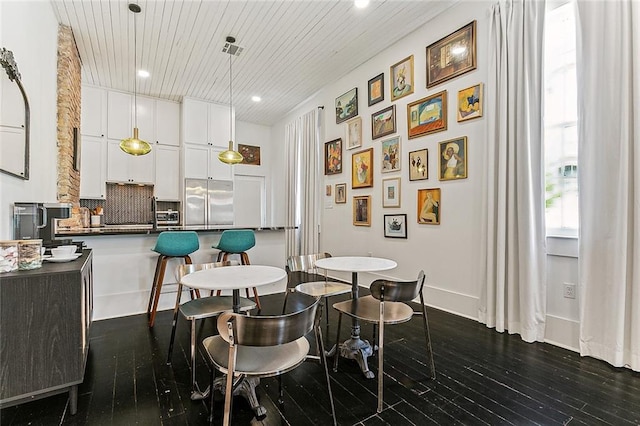 dining space featuring wood ceiling and dark hardwood / wood-style floors