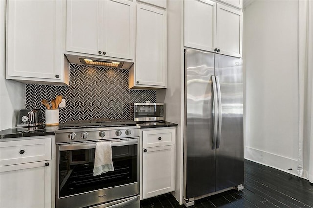 kitchen featuring appliances with stainless steel finishes, backsplash, and white cabinetry