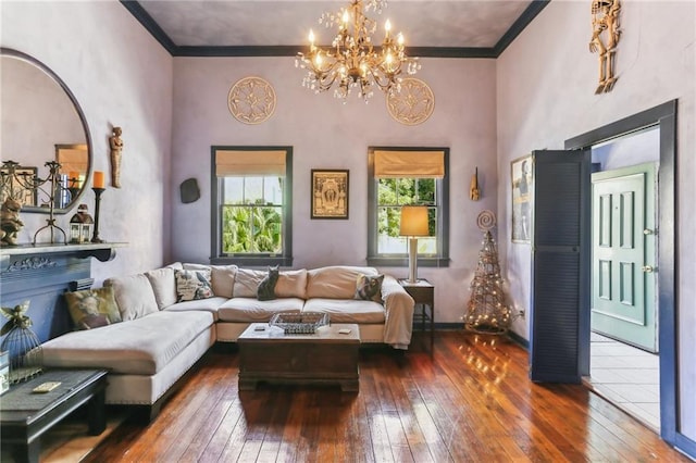 living room featuring crown molding, a towering ceiling, plenty of natural light, and dark hardwood / wood-style floors