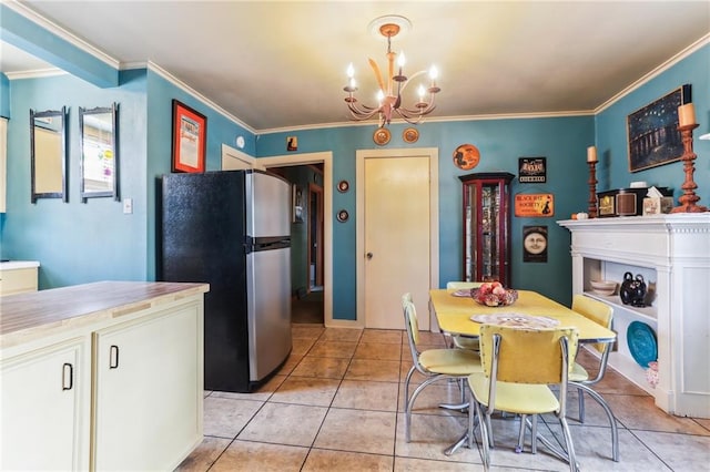 kitchen featuring stainless steel refrigerator, decorative light fixtures, and ornamental molding