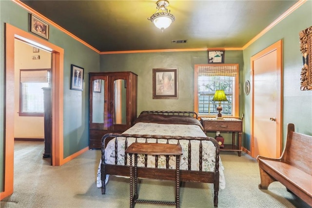 bedroom with crown molding and light colored carpet