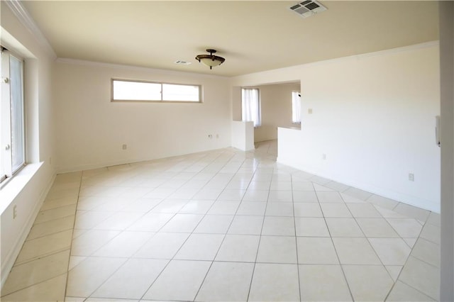 empty room with crown molding and light tile patterned floors