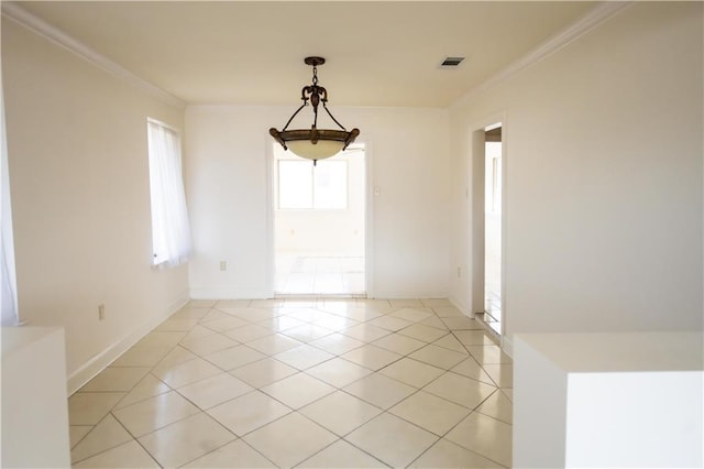 unfurnished dining area with ornamental molding and light tile patterned floors