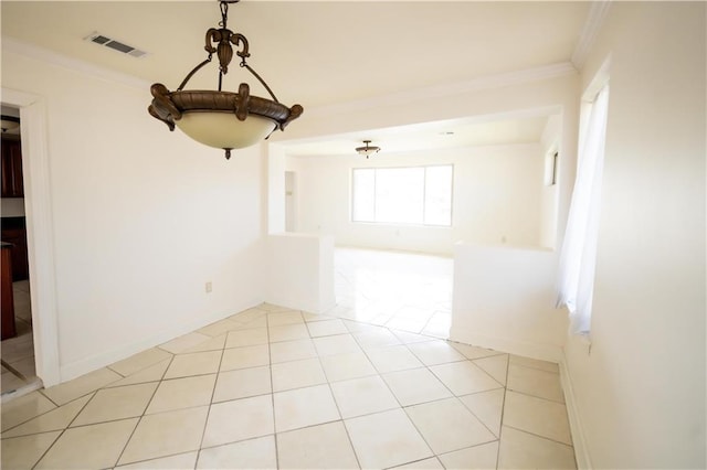 spare room with crown molding and light tile patterned floors