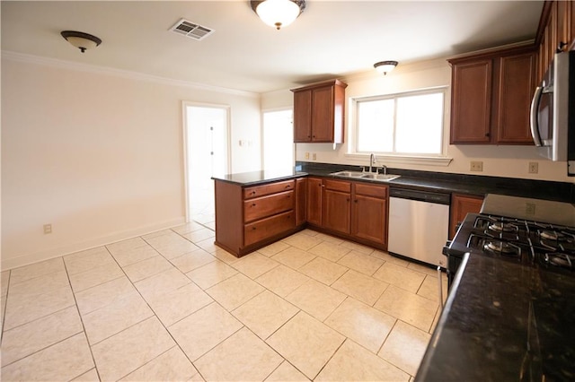 kitchen with kitchen peninsula, dark stone counters, sink, crown molding, and stainless steel appliances