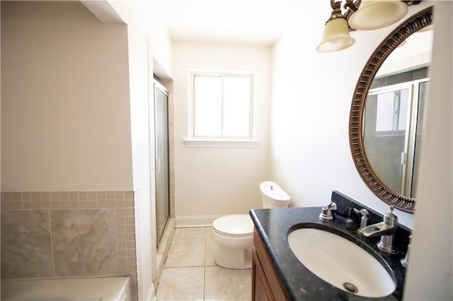 bathroom featuring vanity, a shower with shower door, and toilet