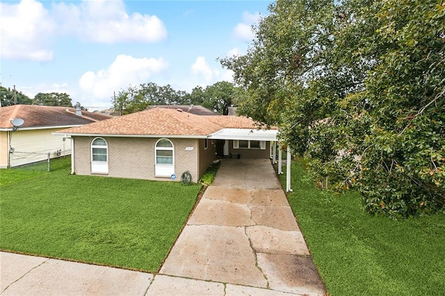 view of front of property with a front lawn and a carport