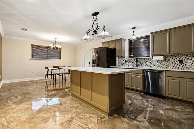 kitchen featuring a notable chandelier, appliances with stainless steel finishes, hanging light fixtures, a center island, and decorative backsplash