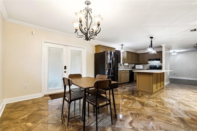 dining space with french doors, a notable chandelier, and crown molding