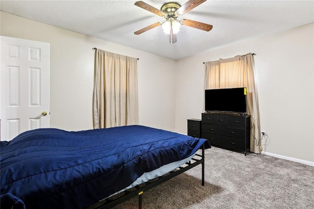 carpeted bedroom featuring ceiling fan and a textured ceiling