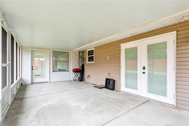 unfurnished sunroom featuring french doors